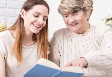 A carer reading with a service user