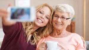 A service user taking a selfie with a carer