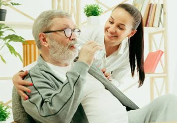A carer sharing a cup of tea with a service user